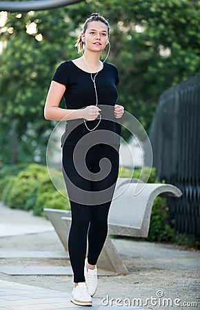 Girl jogging outdoor with music Stock Photo