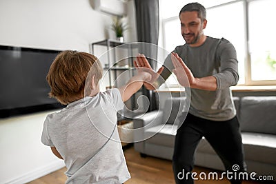 Sporty teen boy child have workout with dad at home Stock Photo
