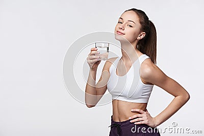 Sporty teen girl with glass of water Stock Photo