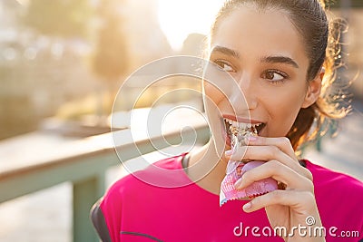 Sporty woman eating energy bar Stock Photo