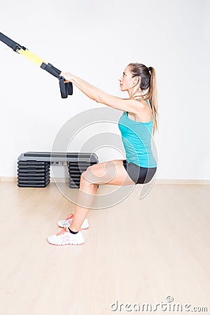 Sporty woman makes suspension training Stock Photo