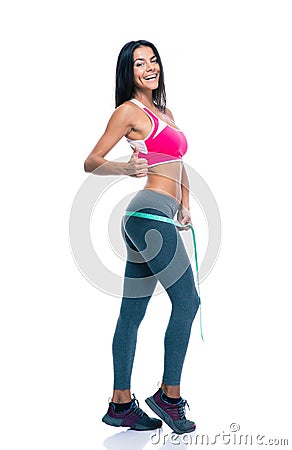 Sporty woman measure her buttocks with a measuring tape Stock Photo