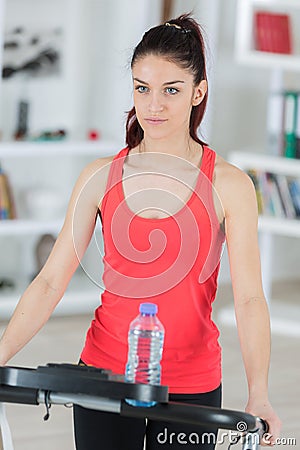 sporty woman training on step machine in bright living room Stock Photo