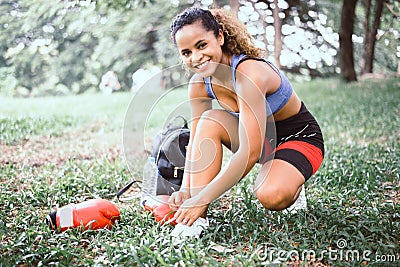 Sporty woman tying a shoelaces at public park,Women athlete preparing for jogging or run Stock Photo