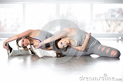 Sporty young females doing exercises for flexibility Stock Photo