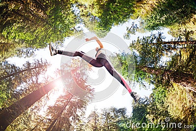 Sporty girl running in sunny forest Stock Photo