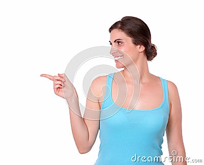 Sporty young woman pointing to her right Stock Photo