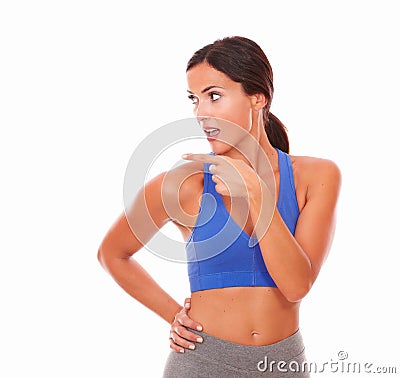 Sporty young woman pointing to her right Stock Photo