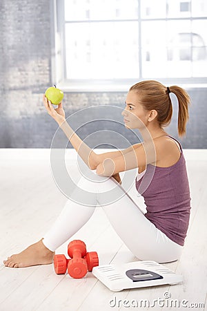 Sporty young woman posing with apple Stock Photo