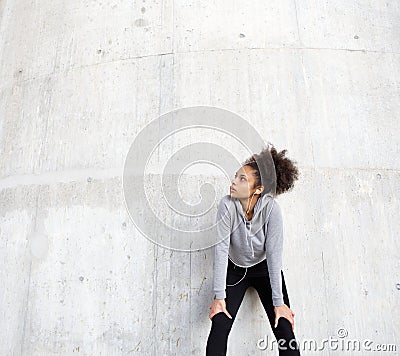 Sporty young woman relaxing outdoors with earphones Stock Photo