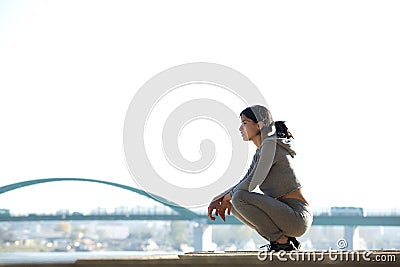 Sporty young woman sitting outdoors Stock Photo