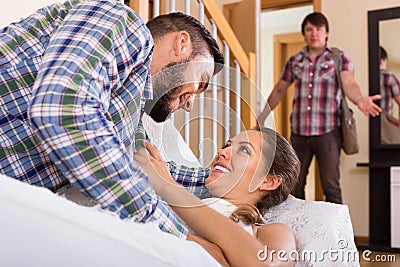 Spouse coming home and saw unfaithful woman Stock Photo