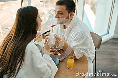 Spouses in love chat nicely over breakfast in cozy atmosphere Stock Photo