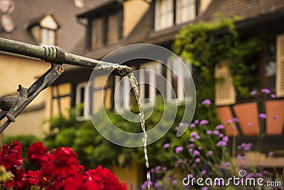 Spout of a spring in small town in Alsace region of France Stock Photo