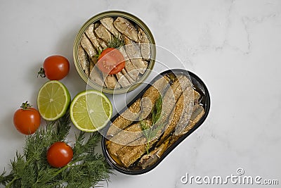 Sprats in a can, fresh healthy lunch gastronomy gourmet nutritious delicious dill lime lunch on wooden background Stock Photo