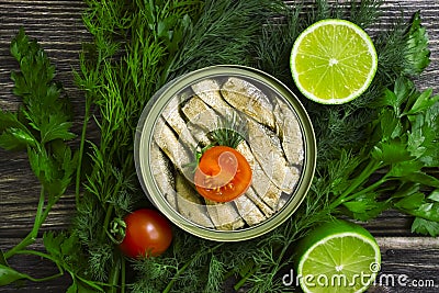 Sprats in a can, fresh healthy gastronomy gourmet nutritious delicious dill lime lunch on wooden background Stock Photo