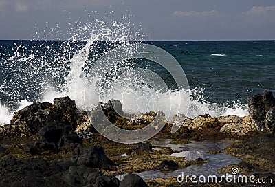 Spray on Lava Rocks Stock Photo