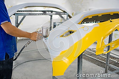 Spray paint, yellow front bumper Stock Photo