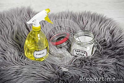 Spray white vinegar dilution with water and baking soda Sodium bicarbonate in glass jar. Stock Photo