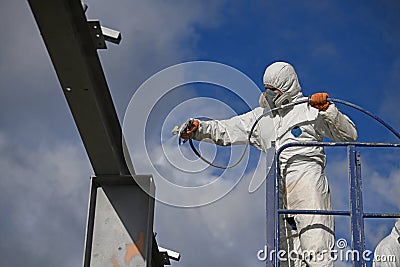 painter spraying the steel beams Stock Photo
