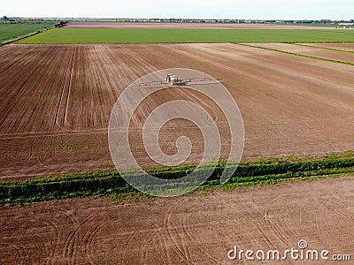 Tractor with sprayer machine working in fields, Zulawy Wislane Stock Photo