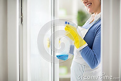 Spraying on window with cleanser Stock Photo