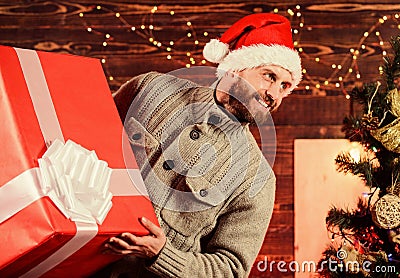 Spread happiness. Giving happiness. Winter happiness. Happy holidays. Santa Claus. Smiling guy with giant gift box. I am Stock Photo
