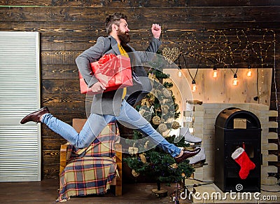 Spread happiness and joy. Bearded guy in motion jump. Delivery christmas present. Gifts delivery. Still have time Stock Photo