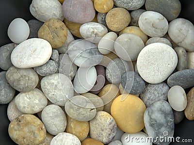 Spread and mixed beach pebbles in soft light Stock Photo