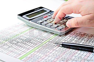 A spread sheet with pen and calculator. Stock Photo