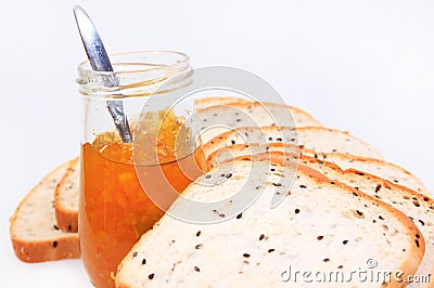 Spread slice brown wholewheat bread and orange jam Stock Photo