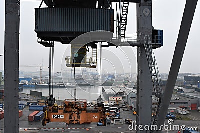 Spreader of gantry container crane for loading of containers Editorial Stock Photo