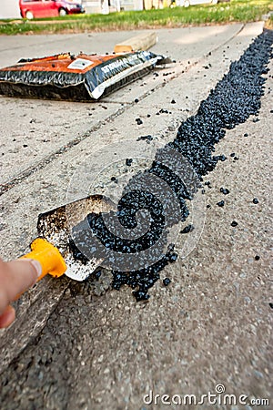 Spreading Asphalt On A Driveway Stock Photo