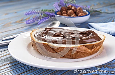 Spreading hazelnut cream on bread, chocolate nut butter Stock Photo