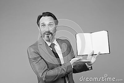 Spreading knowledge. happy man found what he was looking for. businessman is amazed to see inside of book about success Stock Photo