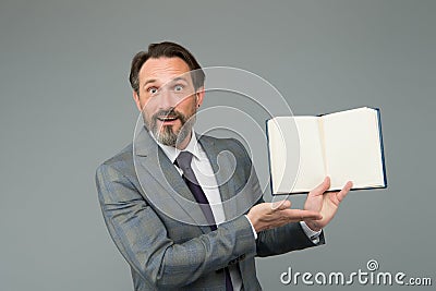 Spreading knowledge. happy man found what he was looking for. businessman is amazed to see inside of book about success Stock Photo