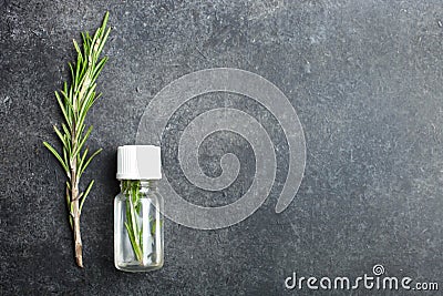 Sprig rosemary and bottle aroma oil Stock Photo