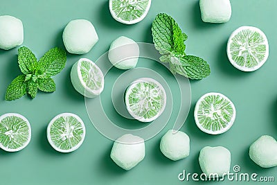 Sprigs of fresh peppermint and halves of peeled limes a green background top view.. Stock Photo