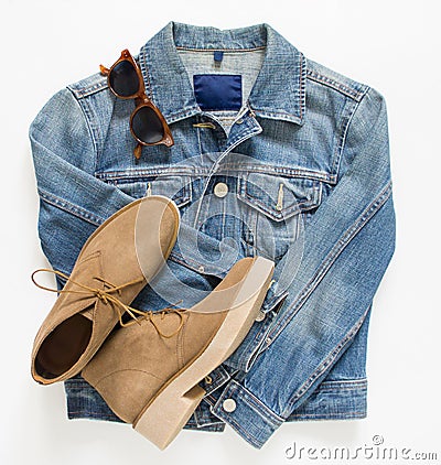 Spring, autumn female outfit. Set of clothes, shoes and accessories on white background. Blue denim jacket and camel shoes. Stock Photo