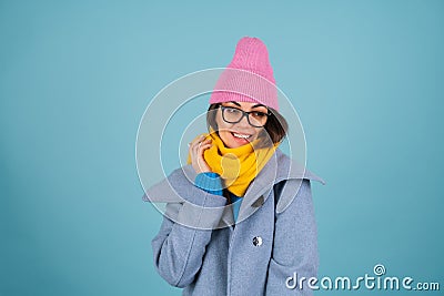 Spring autumn portrait of a woman in a blue knitted sweater, glasses, a yellow bright scarf Stock Photo