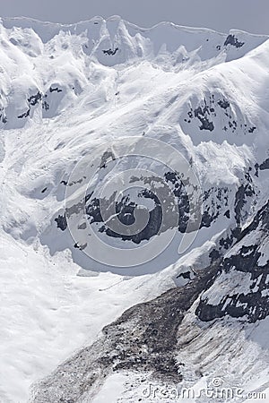 Spring avalanche and snow cornices. Stock Photo