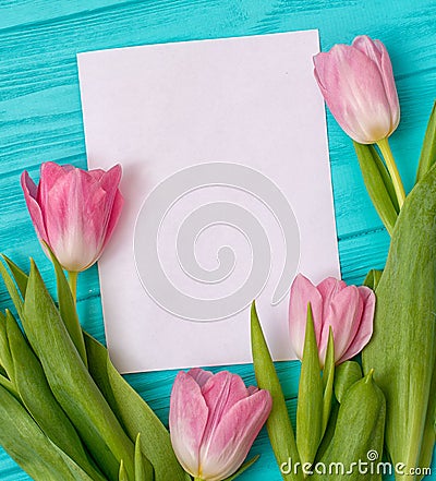 Spring background with bouquet of tulips and blank sheet of paper for romantic entries. Stock Photo