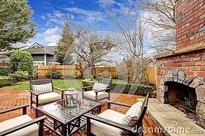Spring backyard with outdoor fireplace and furniture. Stock Photo