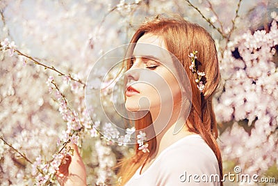Spring beauty girl with long hair outdoors. Blooming trees. Romantic young woman portrait. Nature. Beauty Girl Portrait. Stock Photo