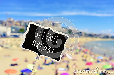 Spring break in a black signboard on the beach Stock Photo