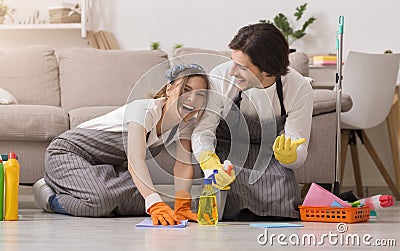 Spring-Clean. Young Couple Having Fun While Cleaning House, Washing Floor Together Stock Photo