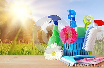 Spring cleaning concept with supplies on wooden table. Stock Photo