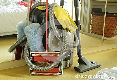 Spring-cleaning or house-cleaning concept wth vaccuum cleaner,carpet sweeper,feather duster and rubber gloves Stock Photo