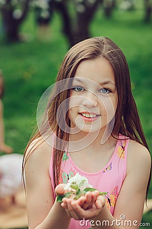 Spring closeup outdoor portrait of adorable 11 years old preteen kid girl Stock Photo
