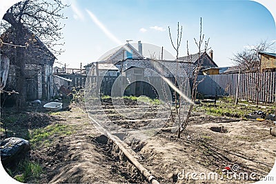 Spring is coming, a vegetable garden, a private plot for planting plants, a watering pipe. Editorial Stock Photo